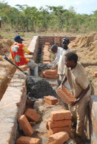 Volunteer workers labor on the foundation.